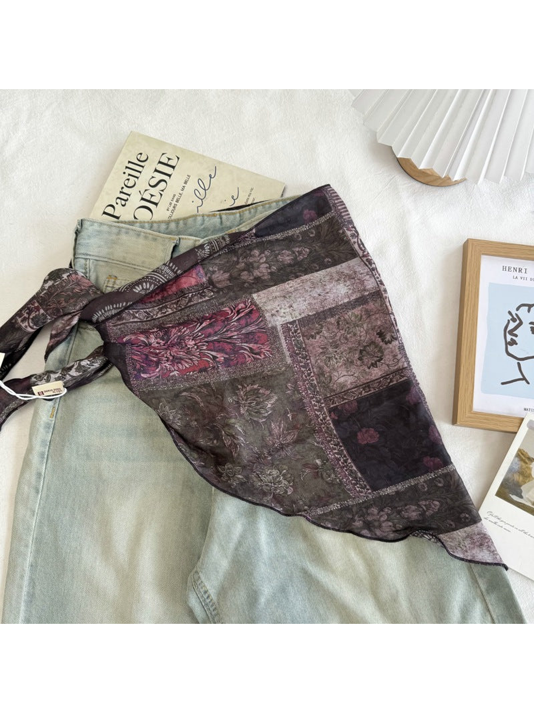 Dark green patchwork floral scarf styled over light-wash jeans