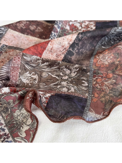Close-up of floral patchwork print and narrow rolled scarf edge