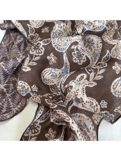 Close-up of the Brown Paisley scarf print and stitched wavy edge