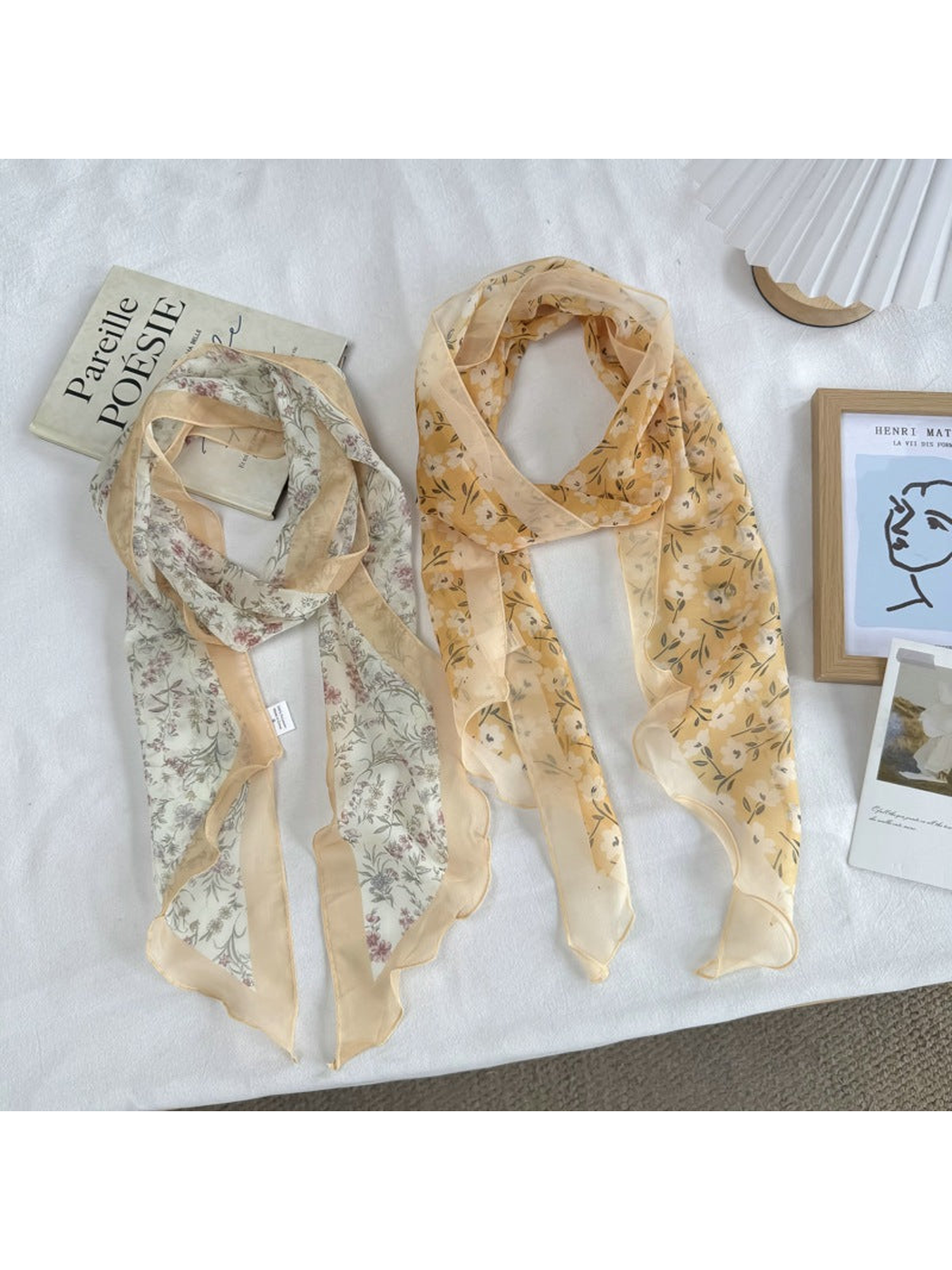 Two warm-toned floral scarf styles displayed in full