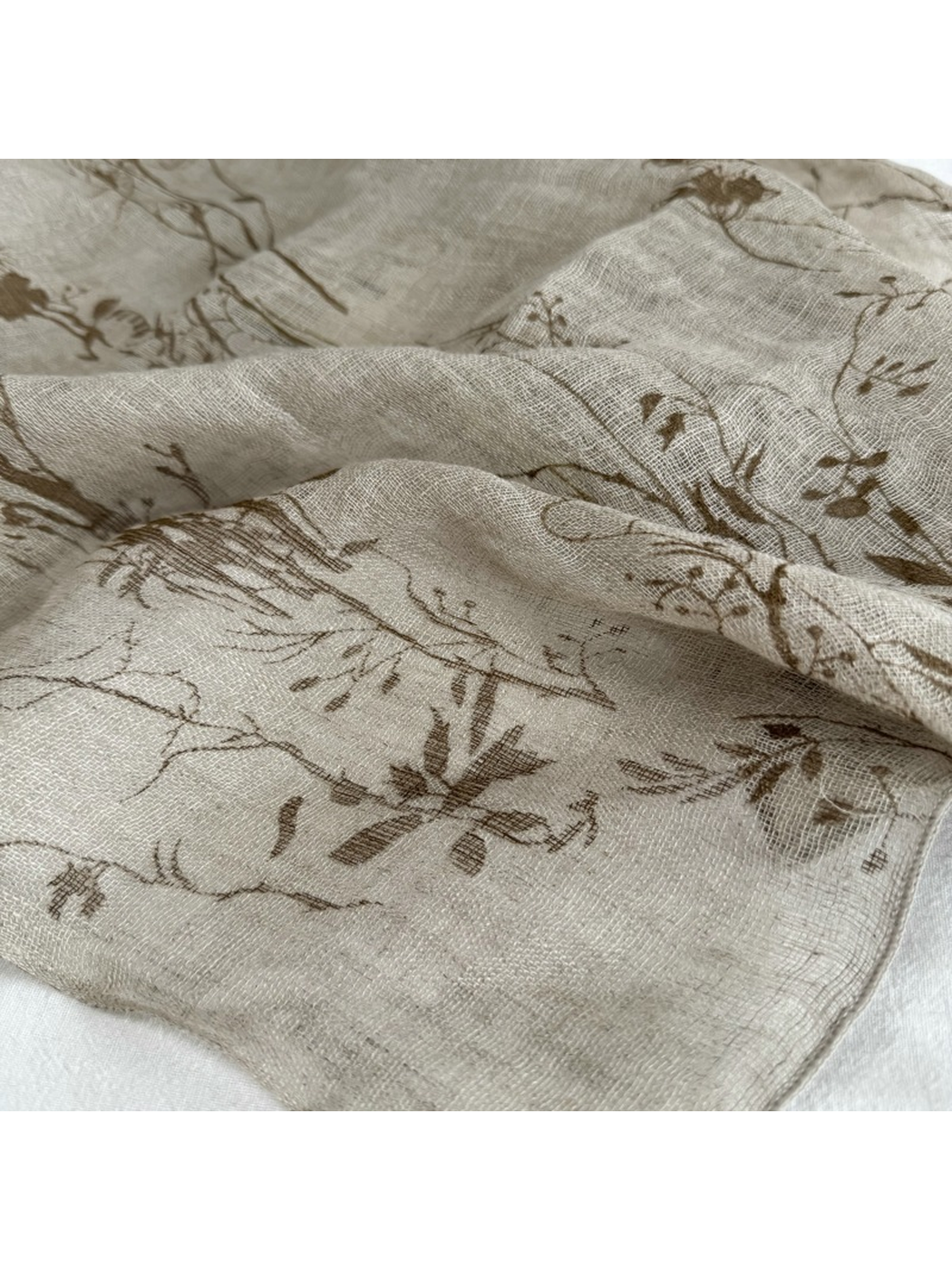 Close-up of the brown botanical branch print and sheer woven-look surface