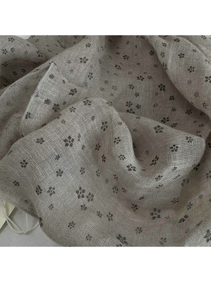 Close-up of the greige floral pattern and open woven texture