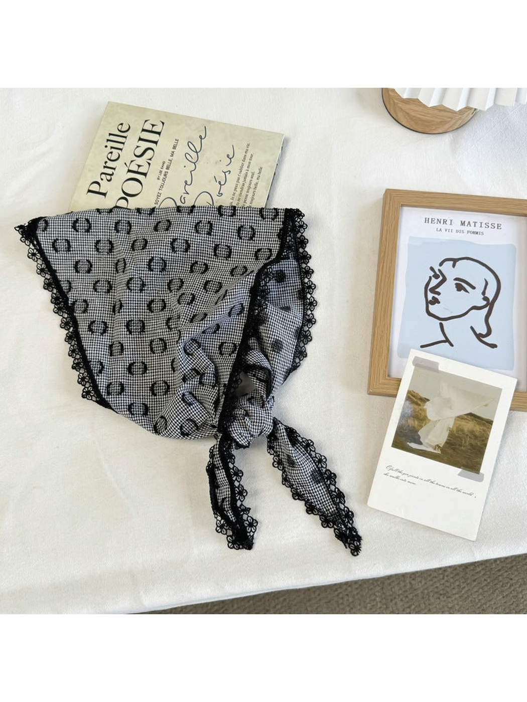 Black triangle scarf with ring motifs, scalloped lace trim and tied ends