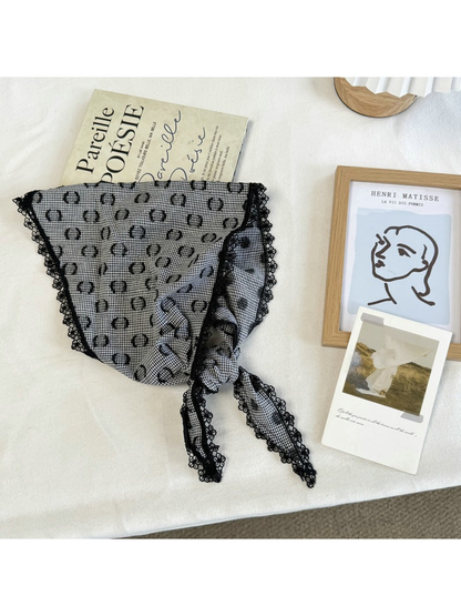 Black triangle scarf with ring motifs, scalloped lace trim and tied ends