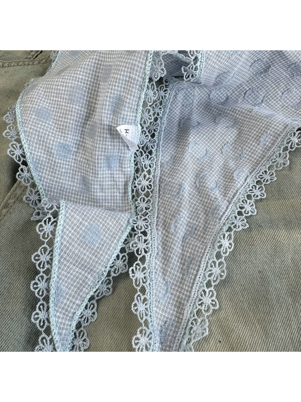 Close-up of the Blue scarf pattern and floral scalloped lace trim