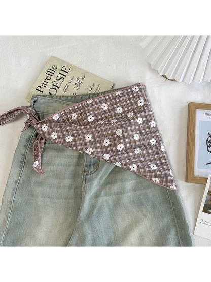 Dusty Pink plaid scarf tied around the waist of pale green jeans