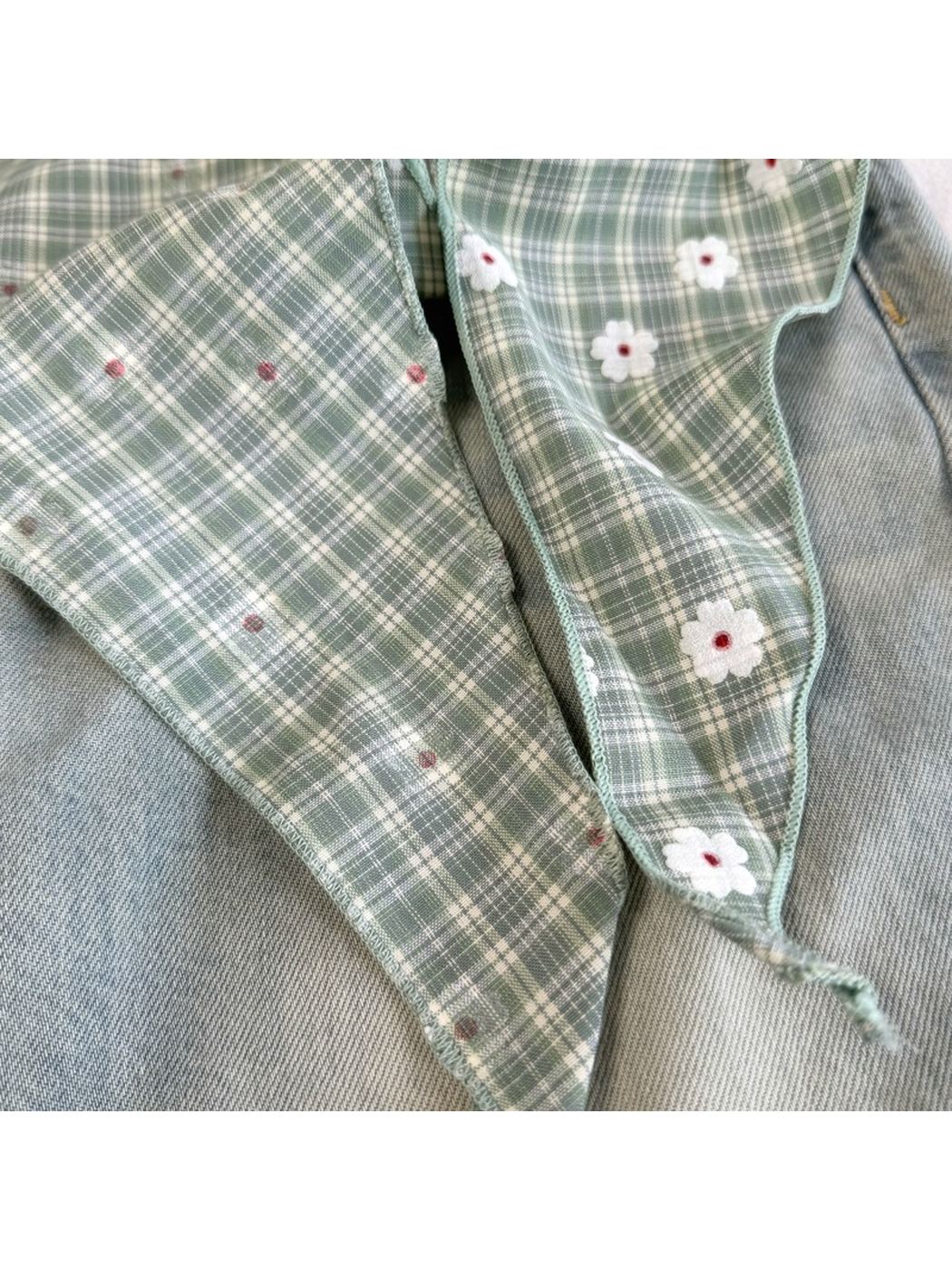 Close-up of the Green scarf tie ends, reverse side and stitched edges
