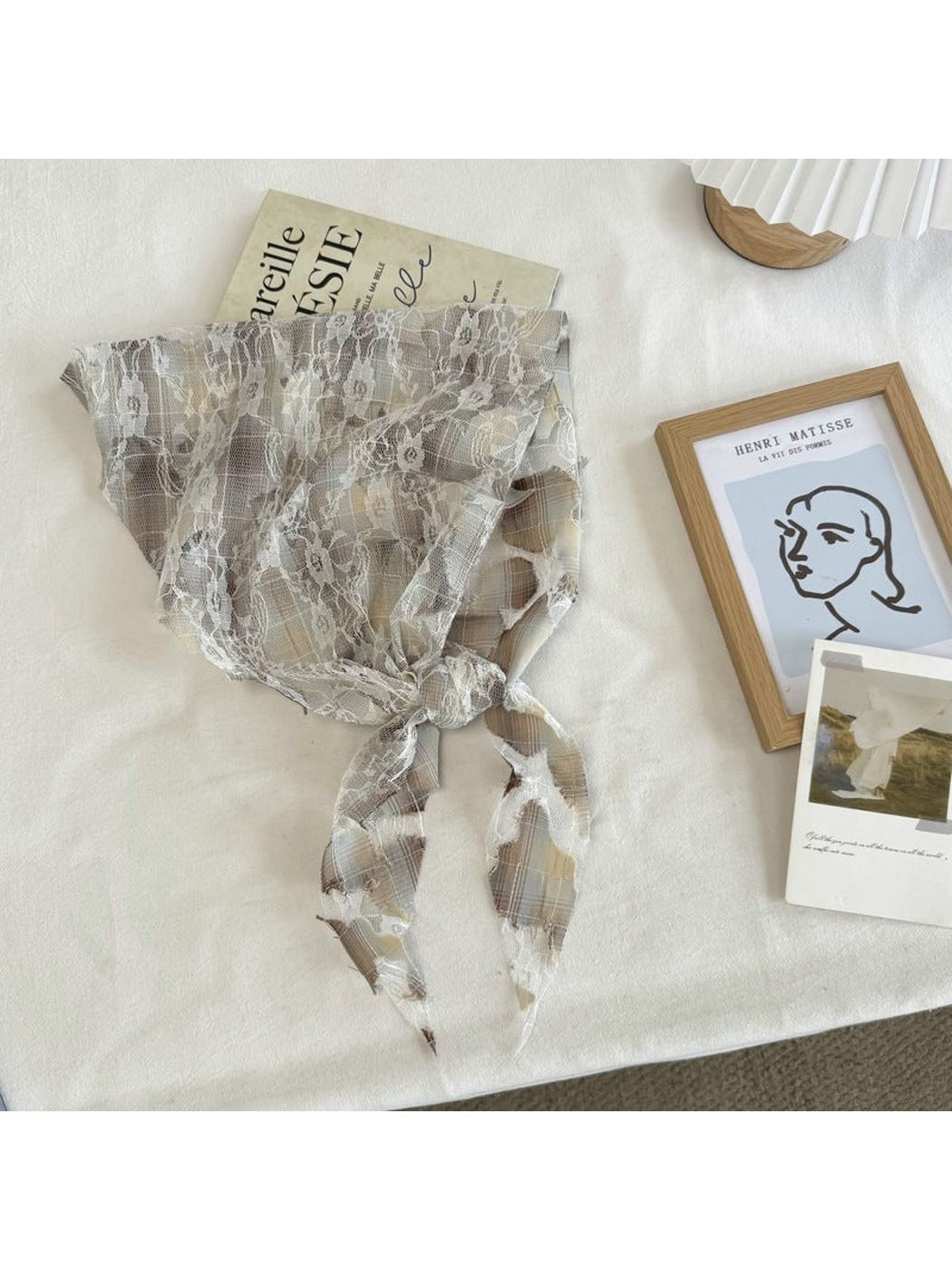 Beige plaid lace scarf with frayed cutout accents, tied view