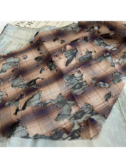 Close-up of Brown plaid with black mesh and frayed cutout details