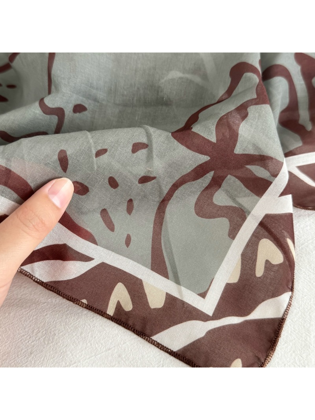 Close-up of the narrow stitched edge and semi-sheer patterned surface