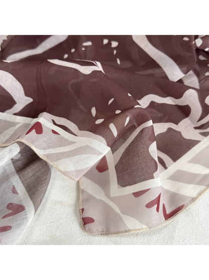 Close-up of the Coffee Faces pattern and light-colored stitched edge