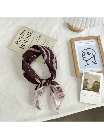 Coffee Faces square scarf arranged in a loose neck-style knot