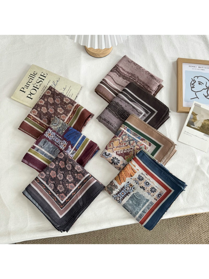 Seven patterned square scarf styles displayed folded together