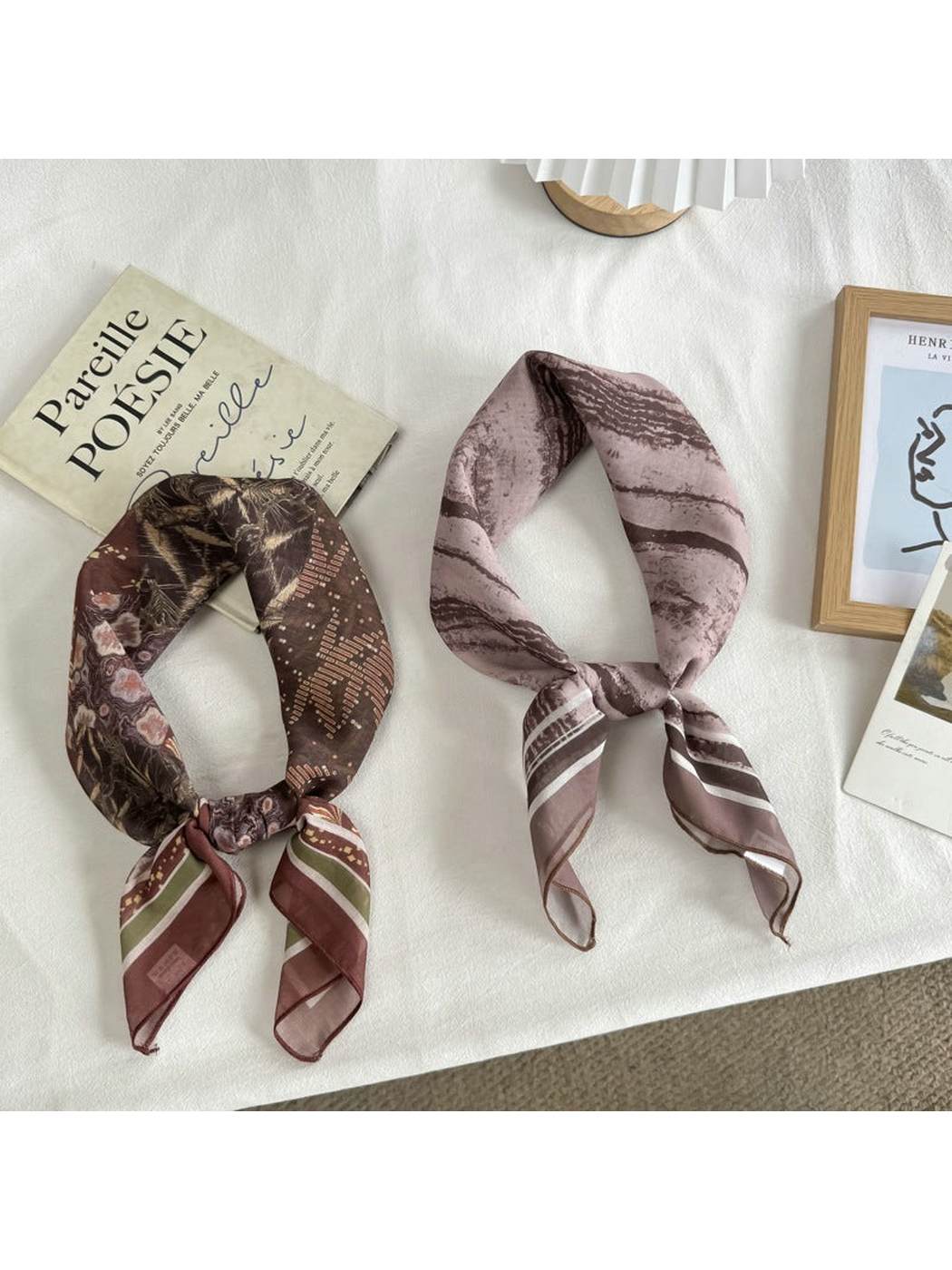 Two patterned square scarves styled with knotted ends