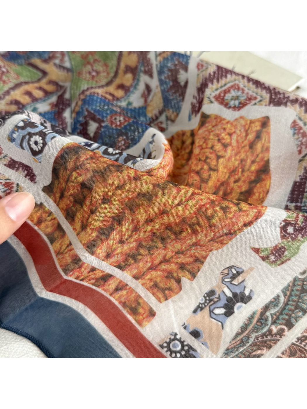 Close-up of the printed pattern and draped scarf surface