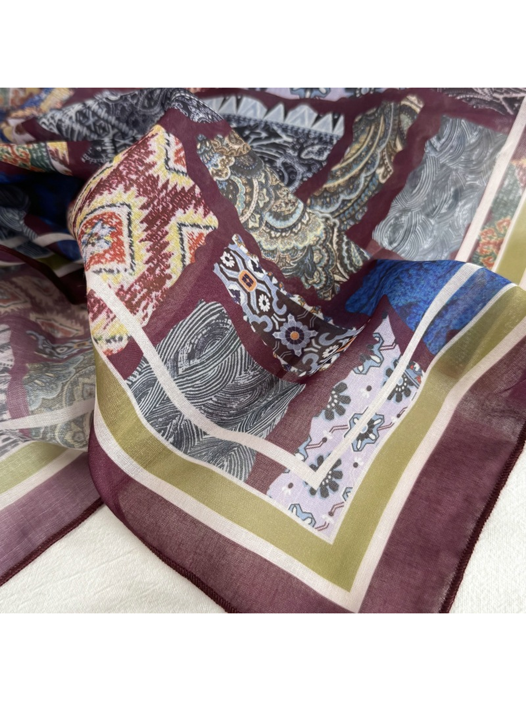 Close-up of a burgundy border and mixed patchwork motifs