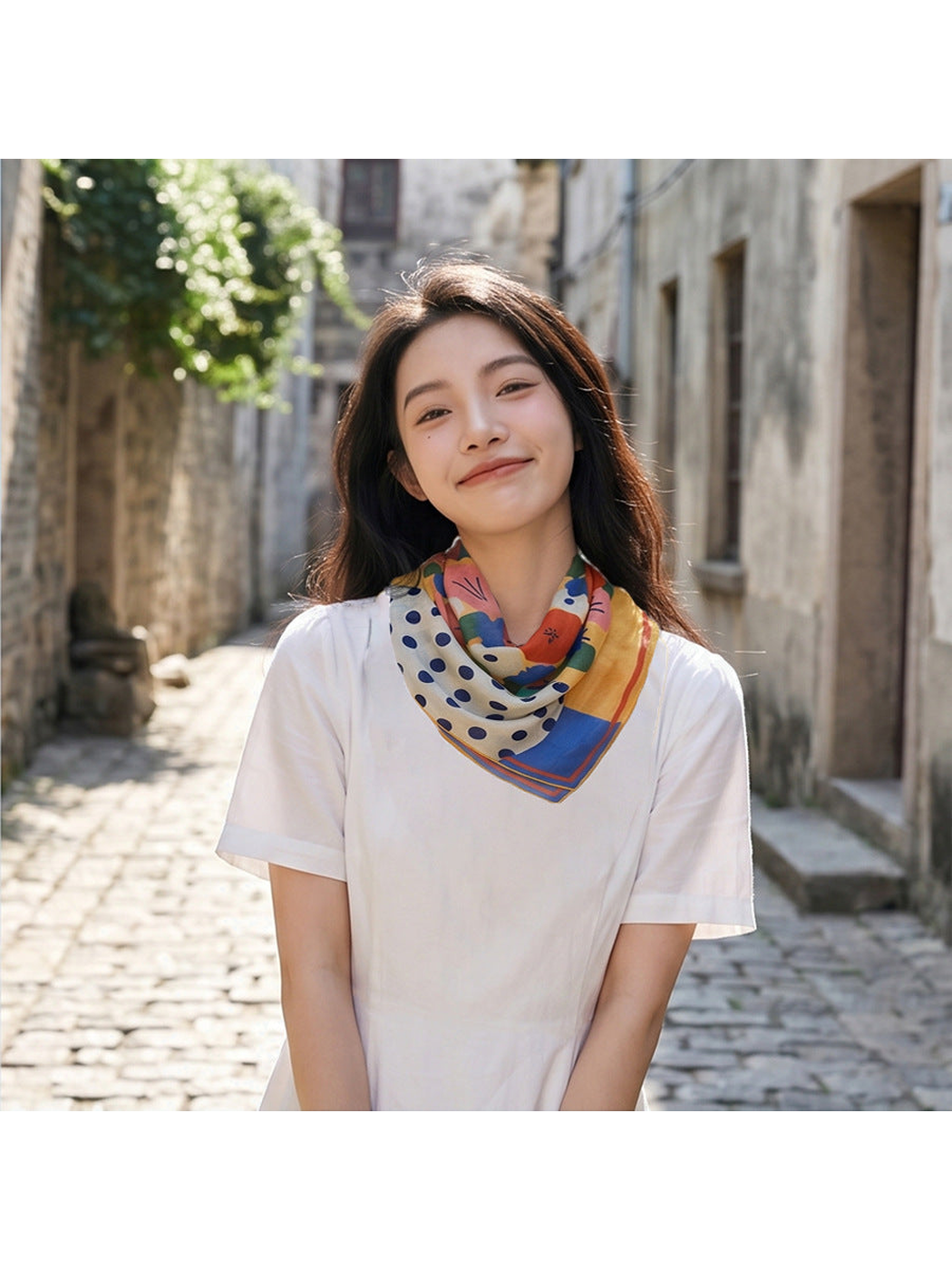 Multicolor floral and polka-dot scarf worn around the neck outdoors