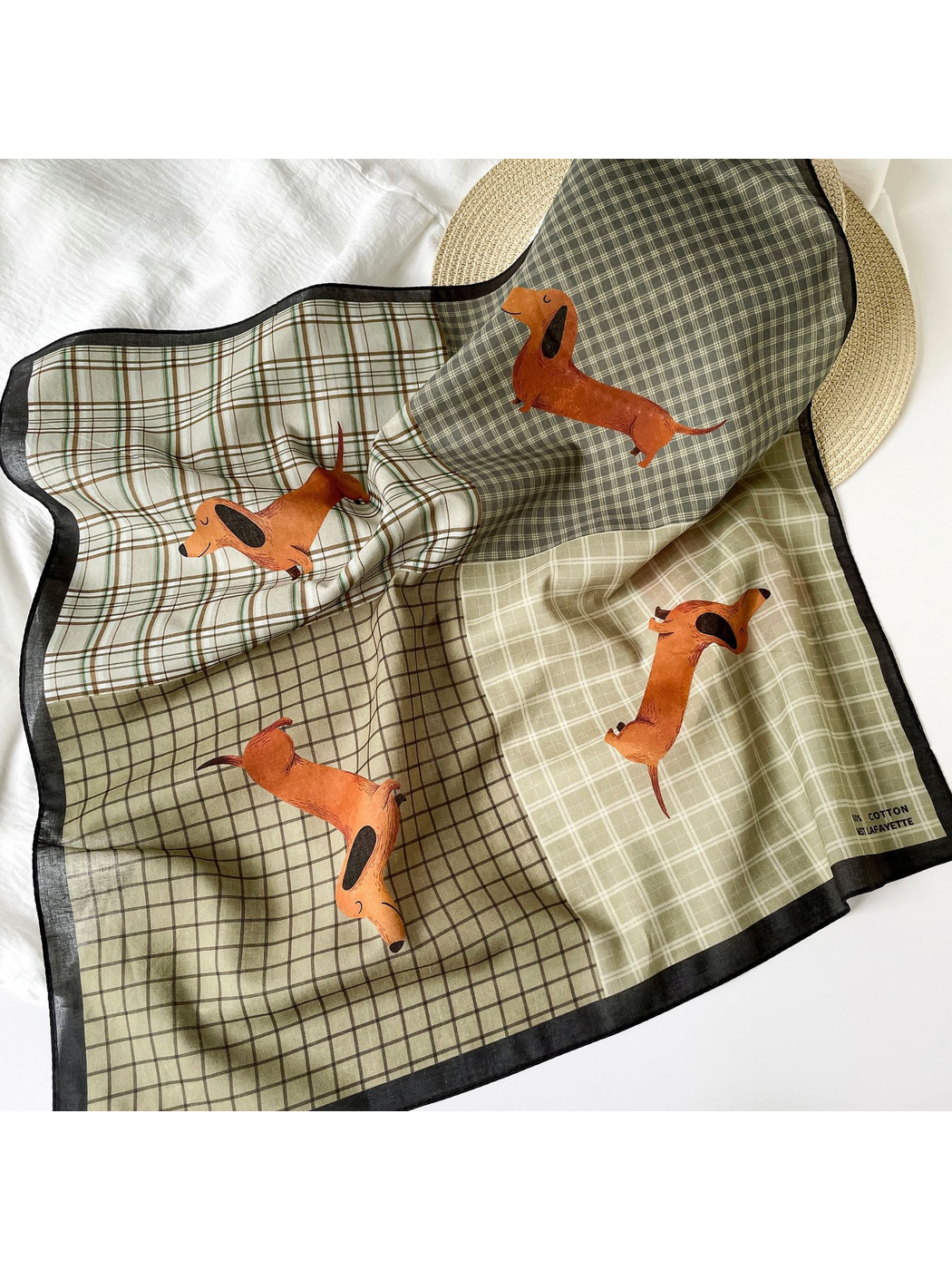 Patchwork plaid dachshund scarf draped in a flat-lay setting