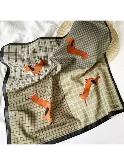 Patchwork plaid dachshund scarf draped in a flat-lay setting