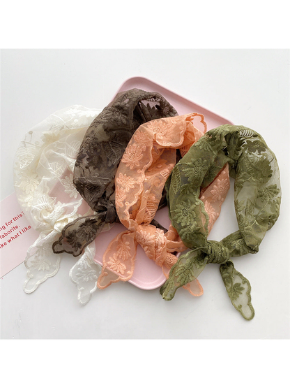 Ivory, brown, orange and army green floral triangle scarves displayed together