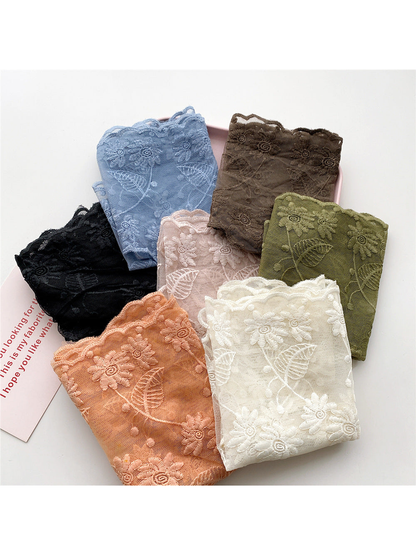 Seven folded color options of the sheer floral triangle scarf