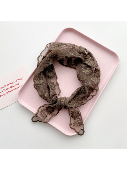 Brown sheer floral triangle scarf tied in a loop