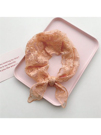 Orange sheer floral triangle scarf tied in a loop