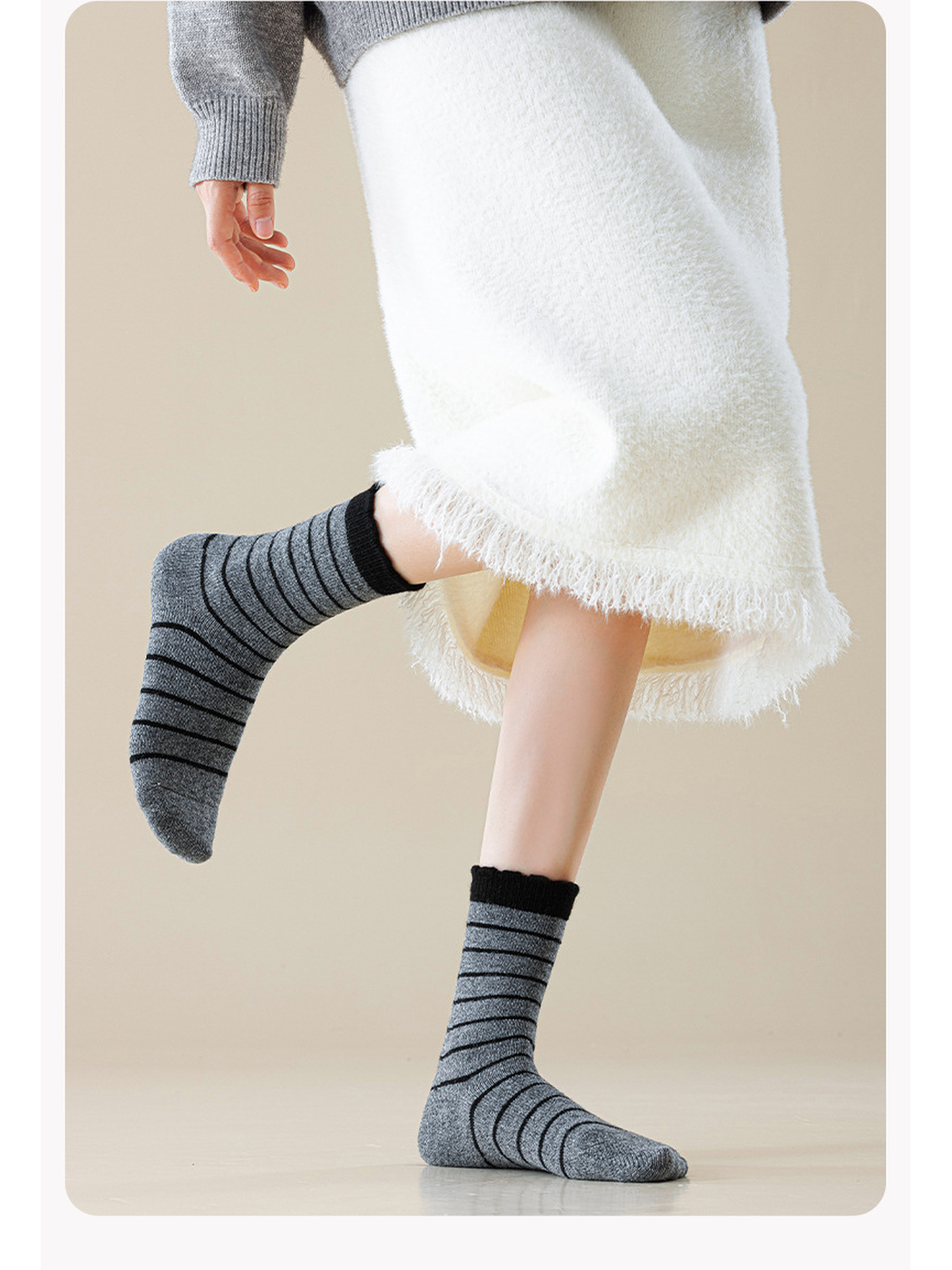 Dark Gray striped crew socks worn with a cream skirt