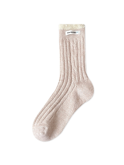 Beige ribbed crew sock with an ivory textured cuff, full view