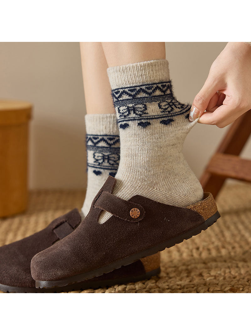 Close-up of a Khaki sock cuff and geometric border being stretched