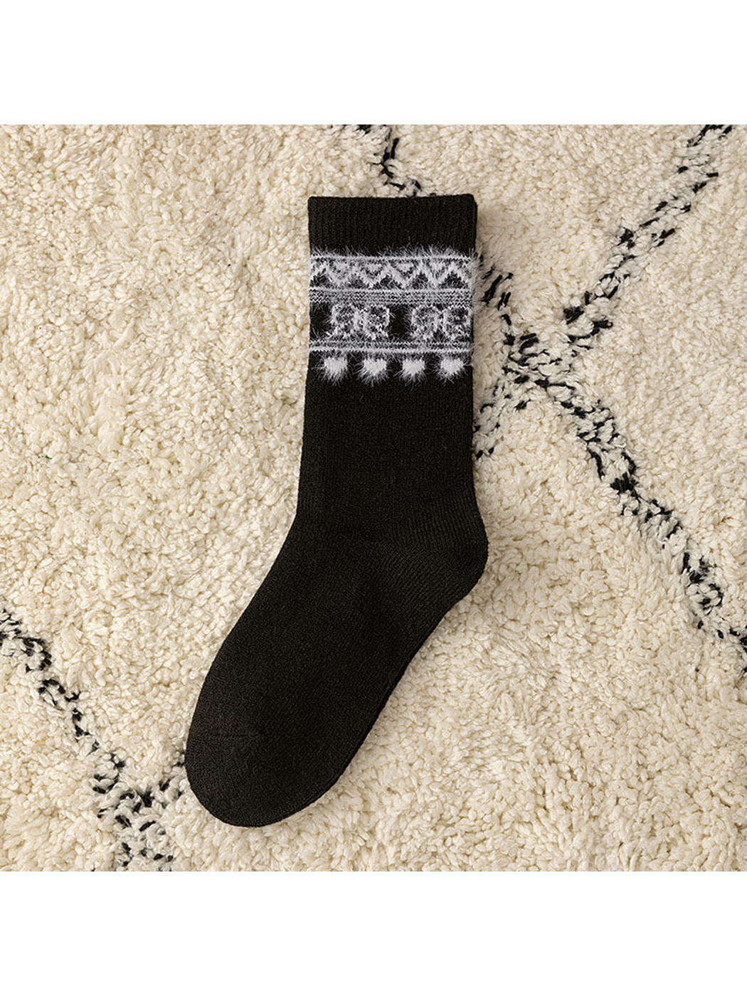 Black crew sock with a contrasting geometric cuff motif, flat view