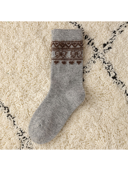 Heather Gray crew sock with a brown geometric cuff motif, flat view