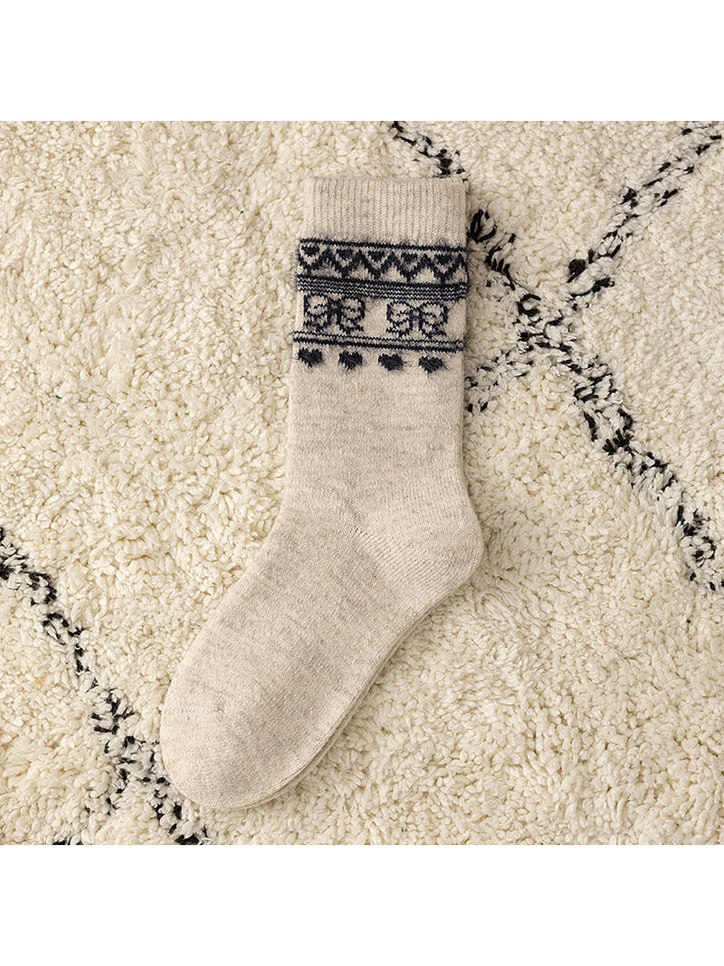 Khaki crew sock with a dark geometric cuff motif, flat view