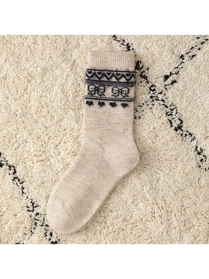Khaki crew sock with a dark geometric cuff motif, flat view