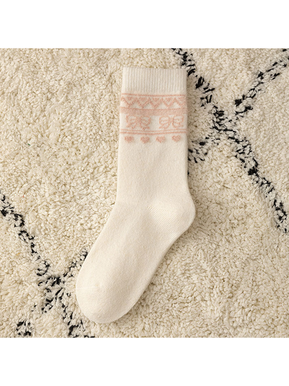 Ivory crew sock with a pale pink geometric cuff motif, flat view