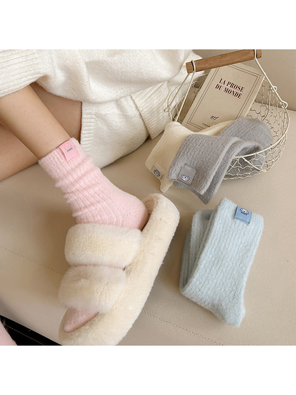 Light Pink ribbed crew socks worn with slippers and additional colors displayed nearby