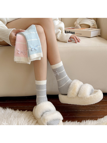 Light Gray striped crew socks worn with slippers beside Pink and Light Blue styles