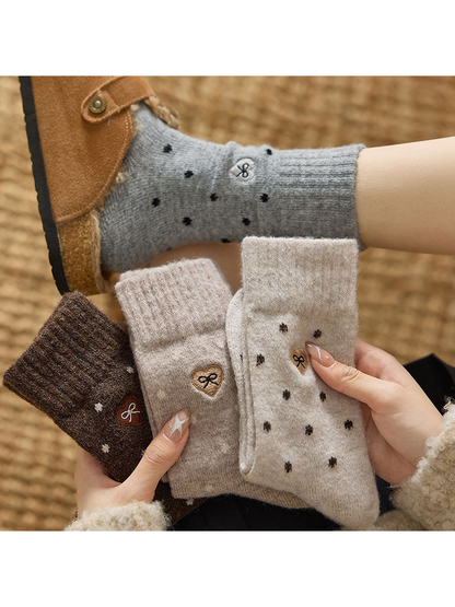 Heather Gray dot-pattern crew socks worn with coordinating colors held in hand