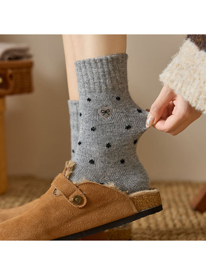 Close-up of Heather Gray dot-pattern crew sock with ribbed cuff and bow patch