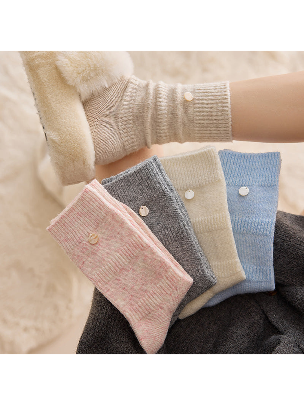 Pink, gray, ivory and light blue crew socks with ribbed bands and round accents