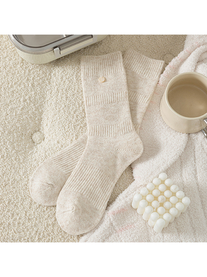 Beige crew socks with ribbed bands and round cuff accent