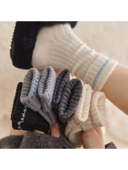 Close-up of ribbed socks with folded contrast-trim cuffs