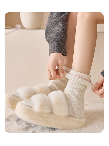 Ivory Pink ribbed socks worn with ivory slippers while the folded cuff is adjusted