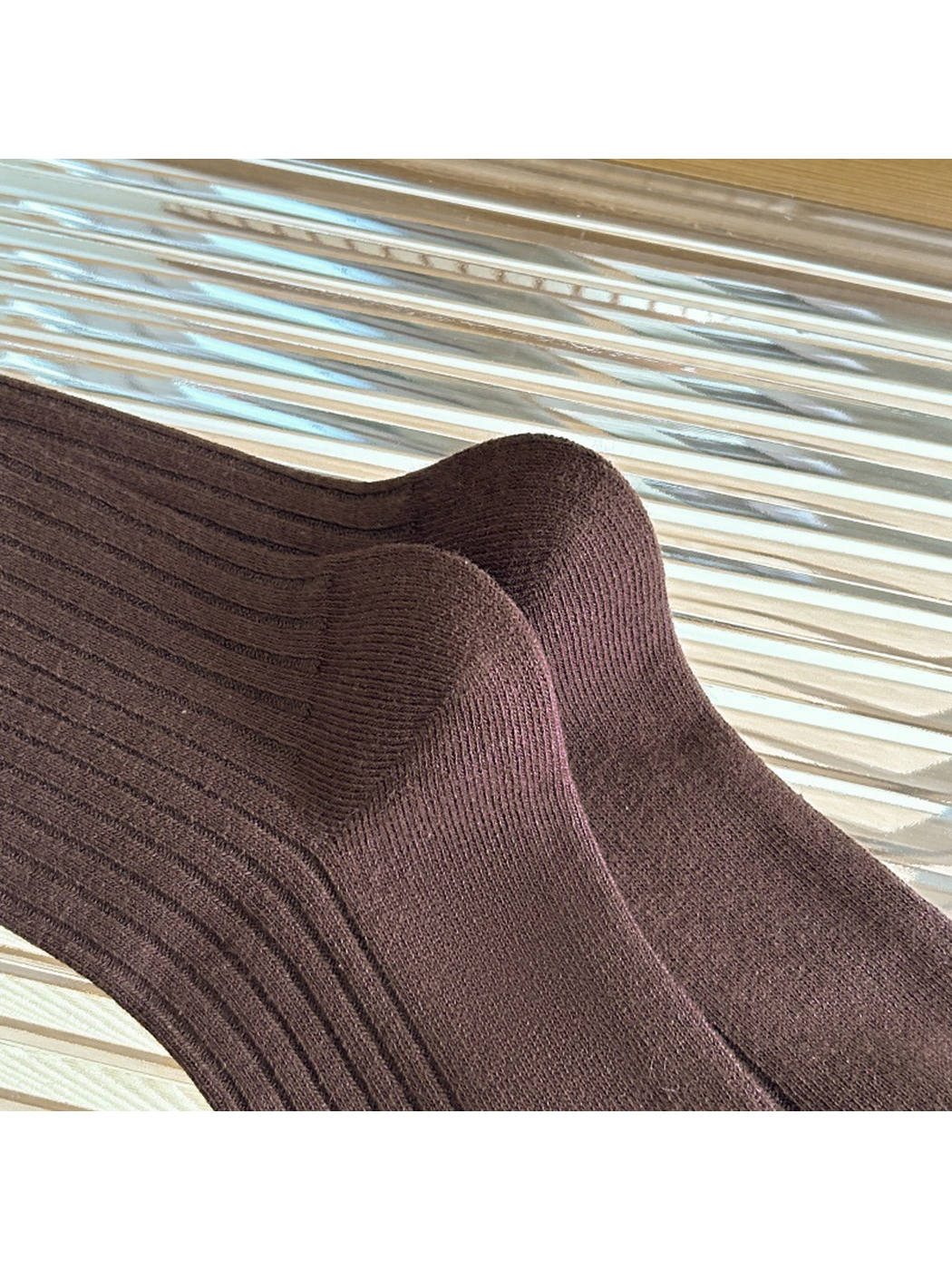 Close-up of the Coffee sock heels and ribbed knit texture