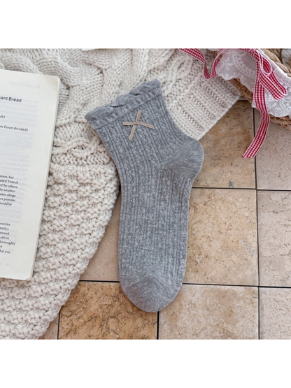 Heather Gray ankle sock with ruffled cuff, ribbon bow, and pointelle texture