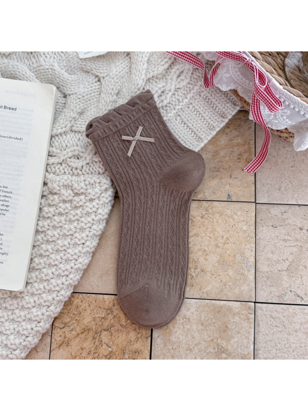 Brown ankle sock with ruffled cuff, ribbon bow, and pointelle texture