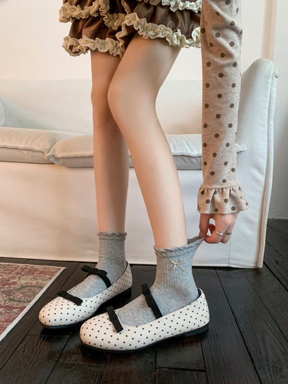 Heather Gray ankle socks with ribbon bows worn with polka-dot flats