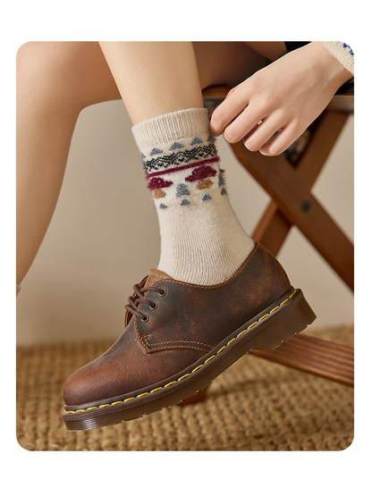 Close view of a Beige mushroom motif crew sock with a brown lace-up shoe