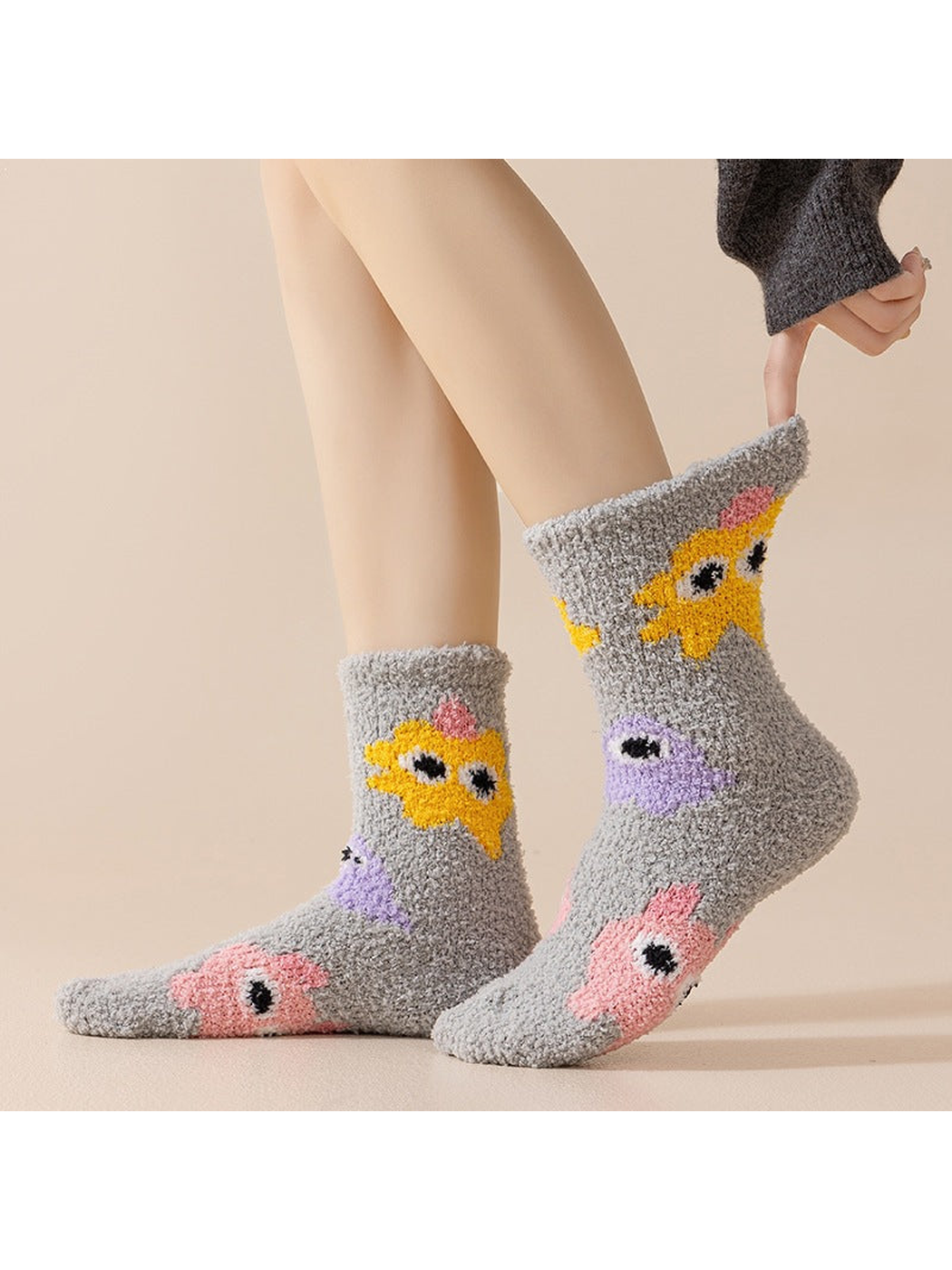 Gray cartoon-motif crew socks worn in a side view