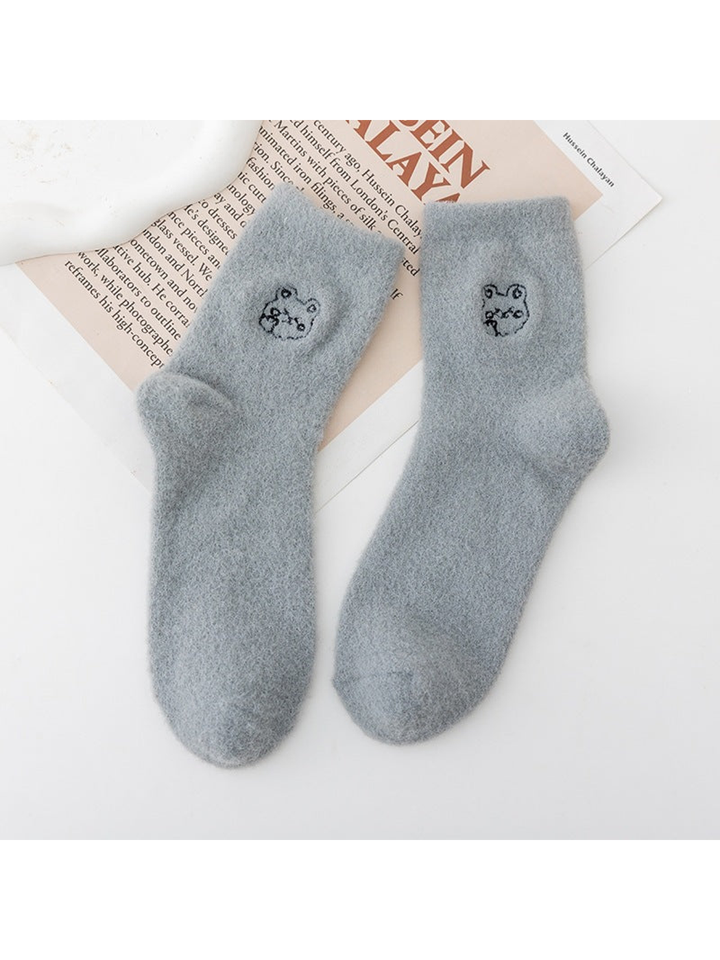 Gray fuzzy crew socks with small outlined animal-face motifs